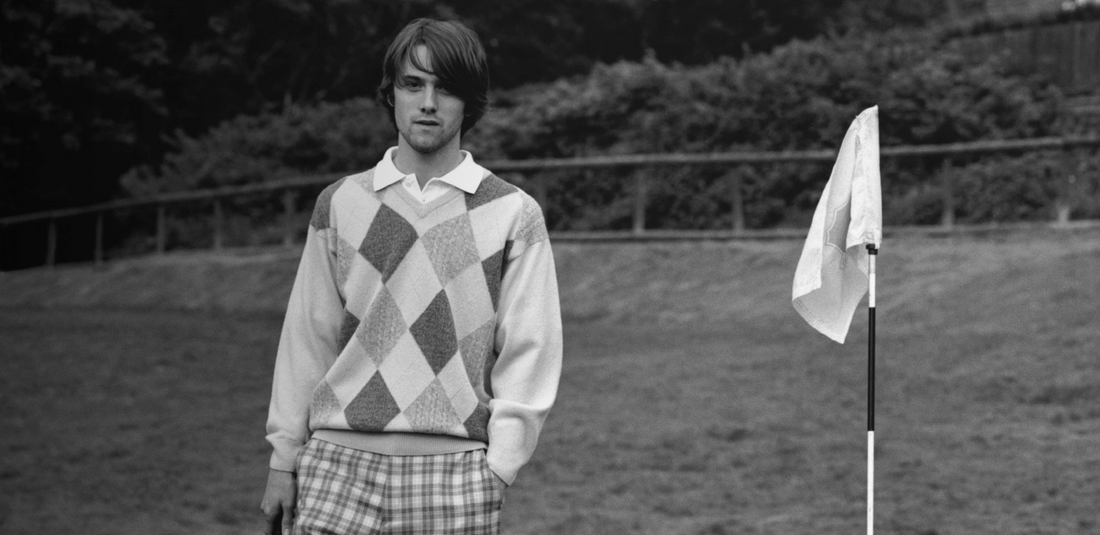 man on golf course in argyle pringle of scotland diamond jumper for reissued pringle campaign