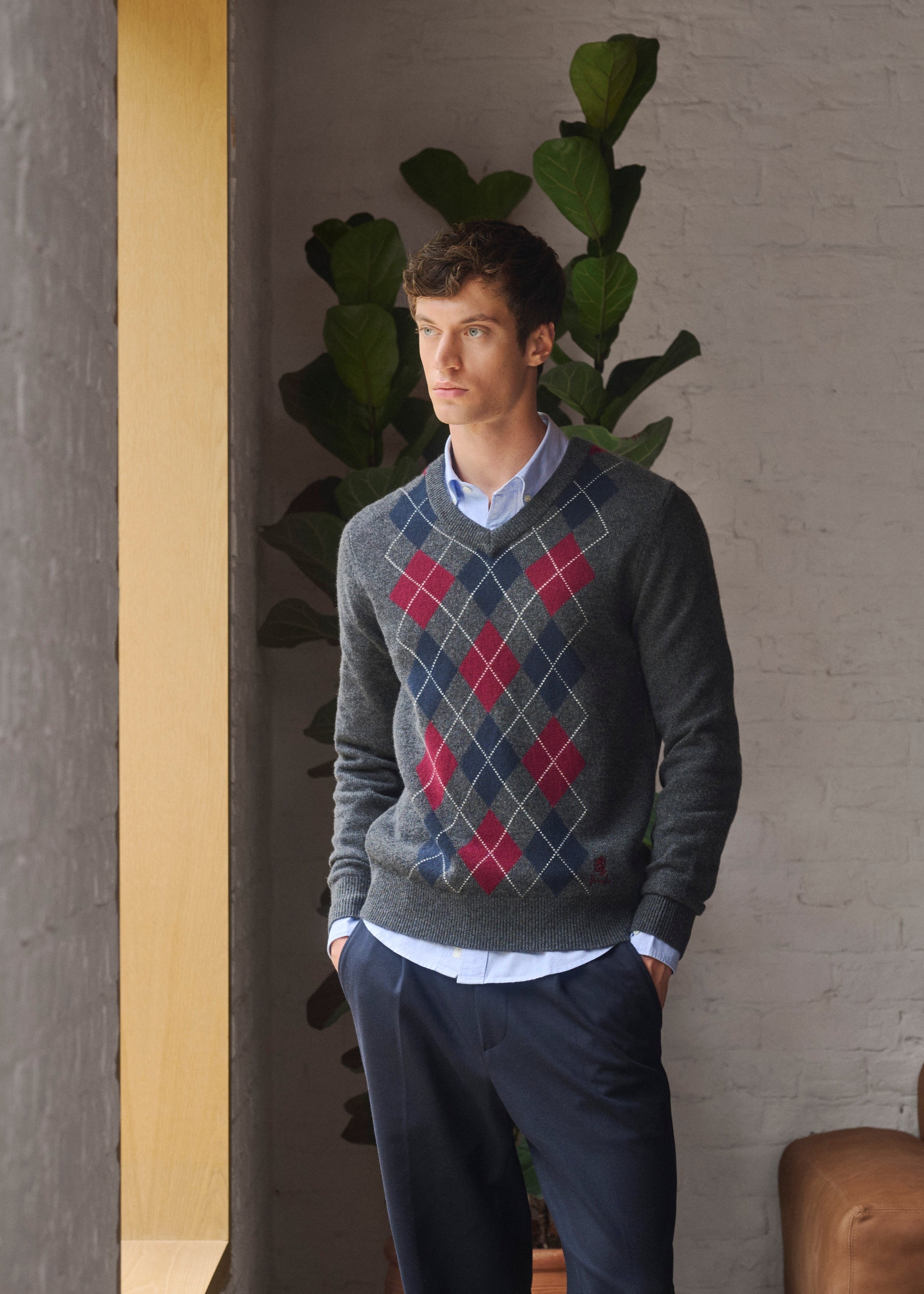 Man wearing Pringle of Scotland Argyle sweater standing in a room 