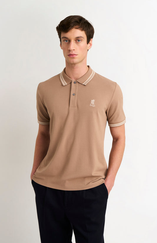 Model wearing a mushroom light brown polo with tipping and Pringle logo on upper side of chest