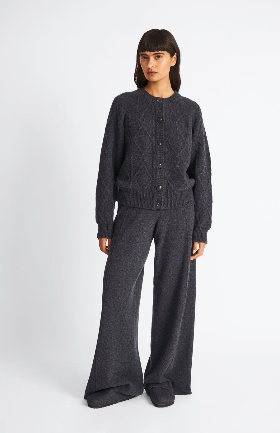 Pringle Multi Texture Cashmere blend cardigan in Charcoal on model with matching trousers
