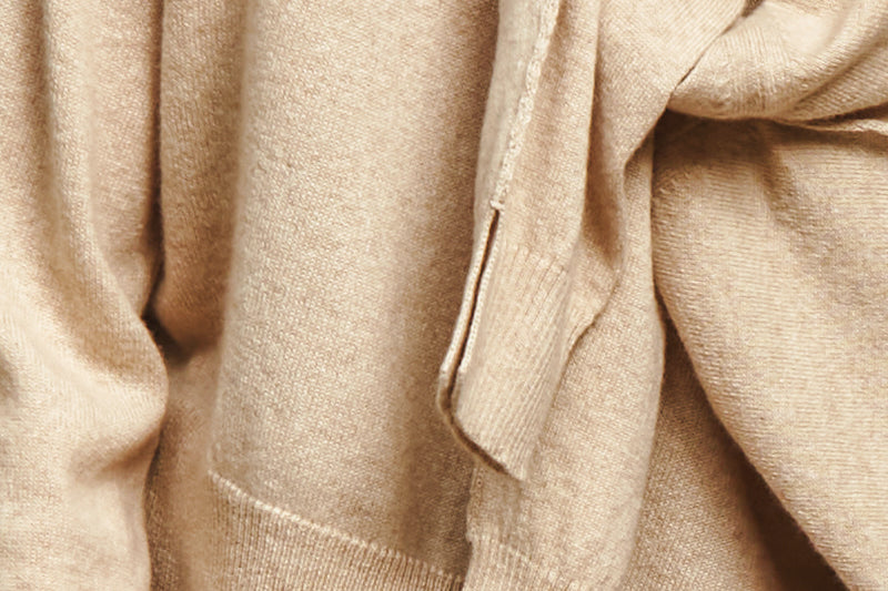 A closeup shot of tan coloured, layered cashmere garments