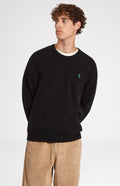 Round Neck Lion Lambswool Jumper In Black/Evergreen on model - Pringle of Scotland