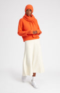 Rib Knit Cashmere Wrist Warmers In Apricot Orange on model full length - Pringle of Scotland