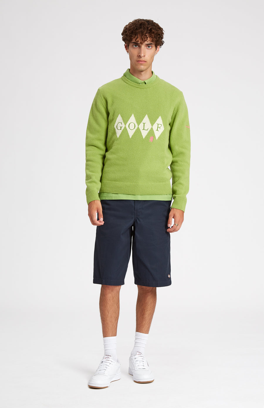 Unisex heritage diamond motif golf jumper in Green and Ivory on male model - Pringle of Scotland