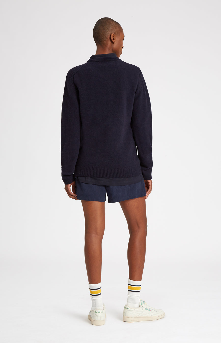 Round Neck Lambswool Golf Jumper In Navy on female model rear view - Pringle of Scotland