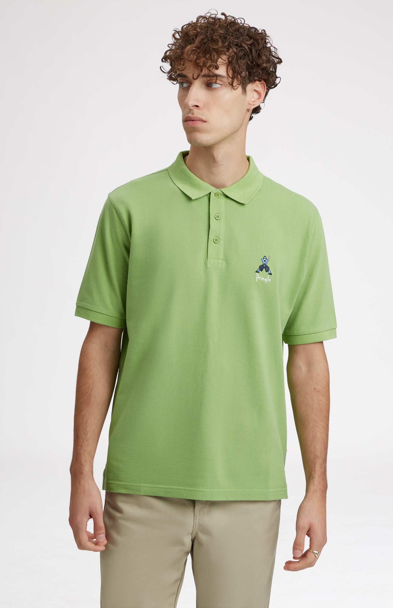 Geometric George Golf Cotton Polo Shirt In Field Green on model - Pringle of Scotland